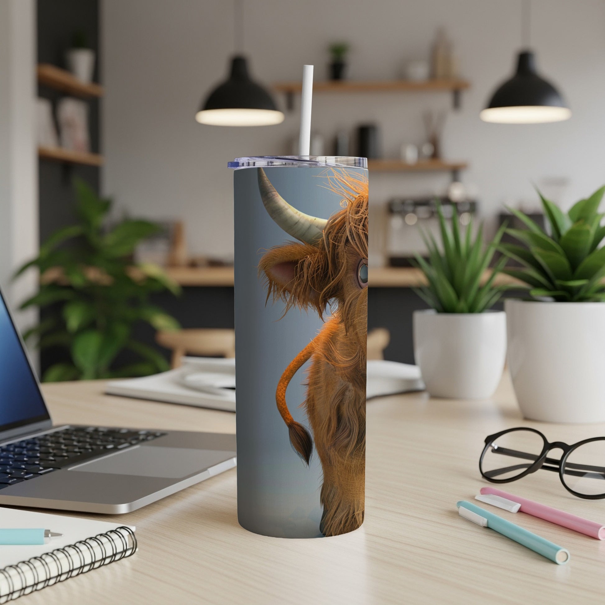 Tall tumbler with a fluffy Highland cow design and a straw.