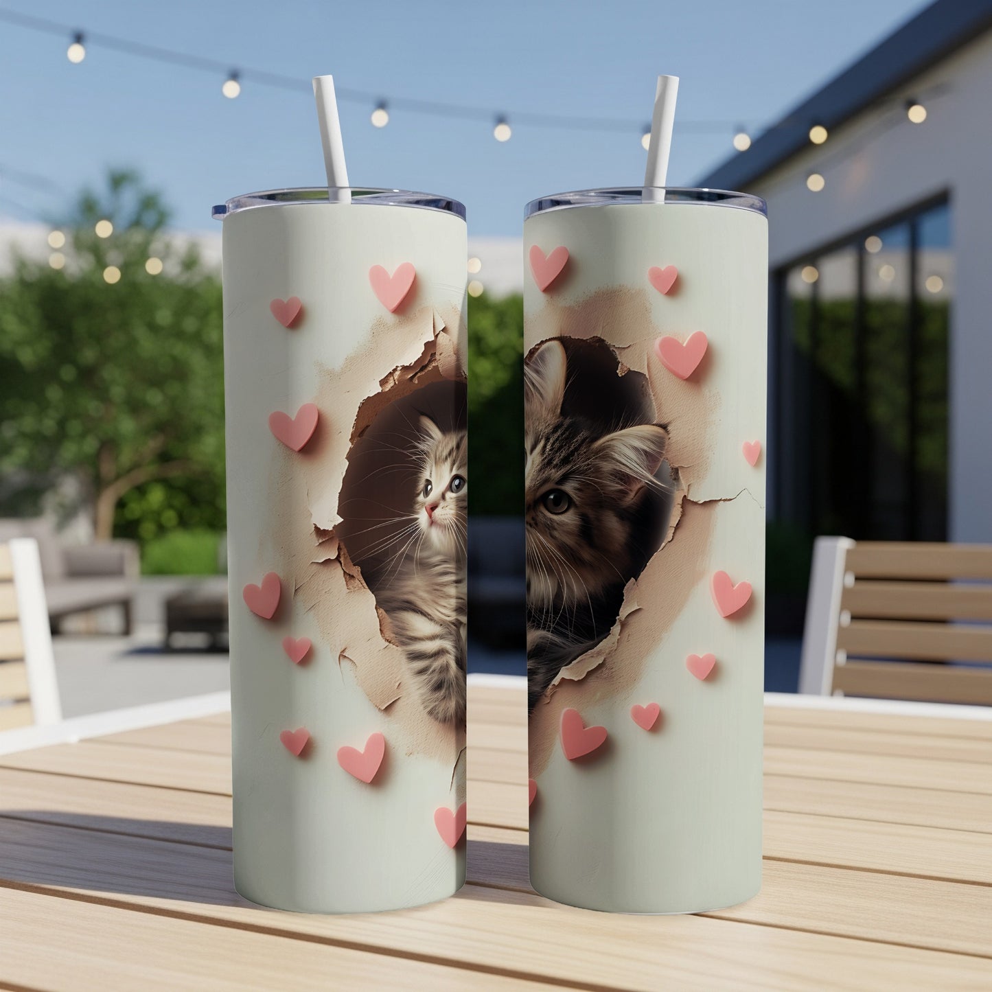 Two tumblers with a kitten peeking through a torn paper heart design.