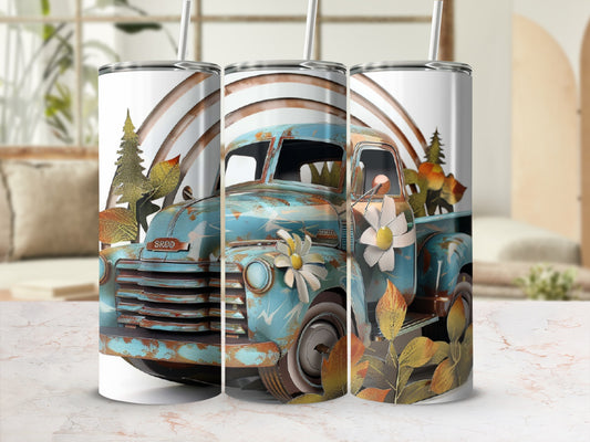 Blue vintage truck with floral and leaf design on a tumbler.
