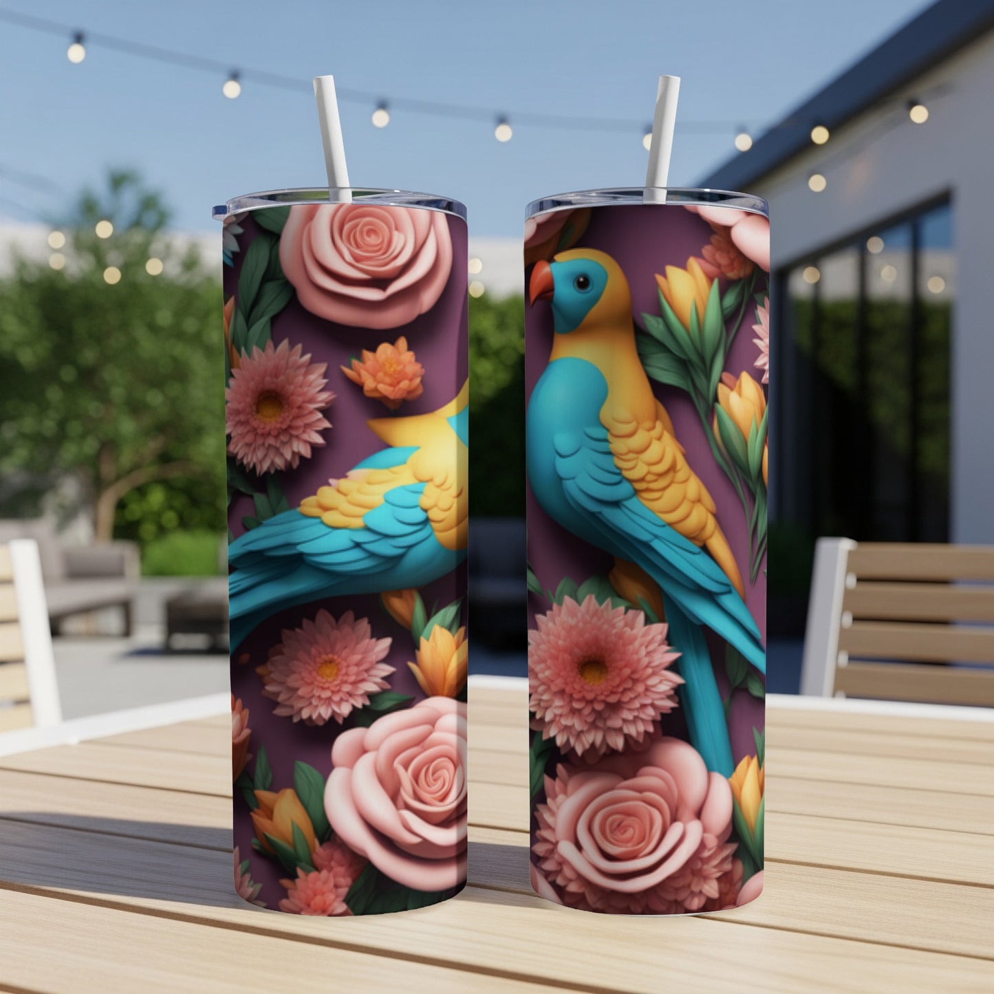 Two tall tumblers with parrots and floral patterns on a table.