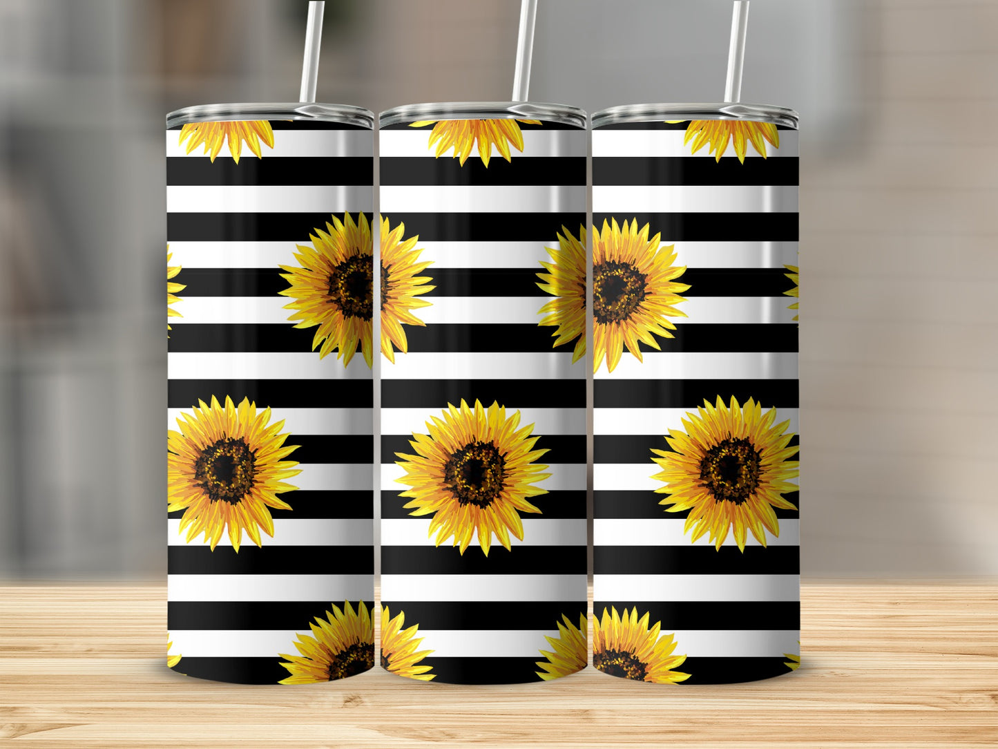 Three tumblers with black and white stripes and sunflowers.