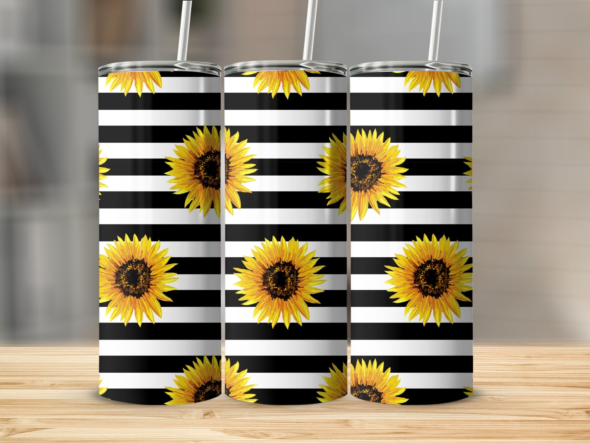 Three tumblers with black and white stripes and sunflowers.