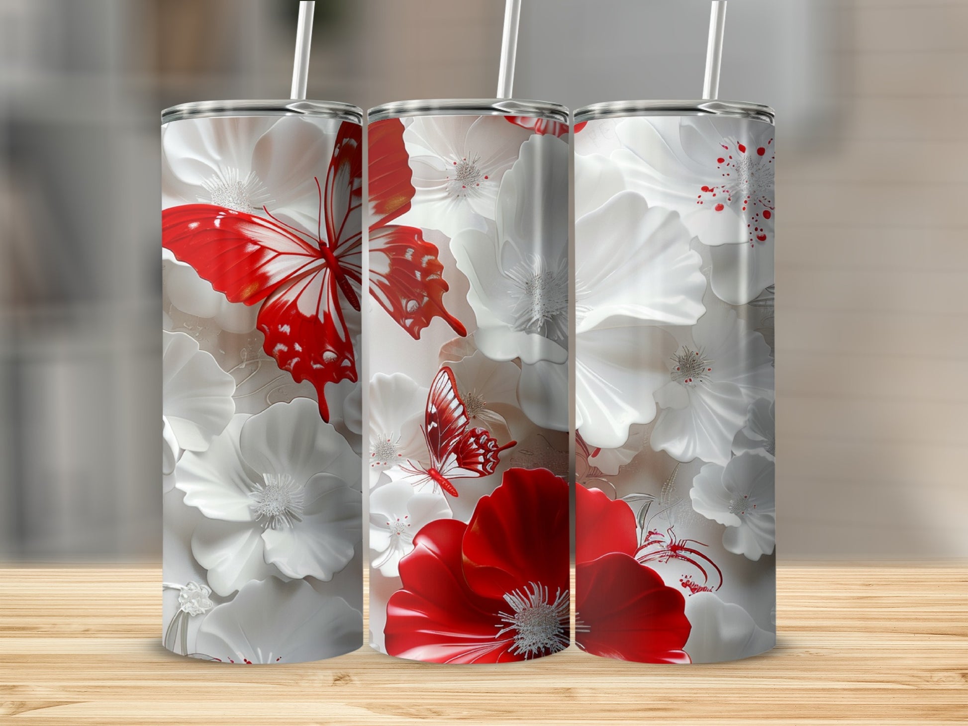 Three white tumblers with red butterflies and white and red flowers.