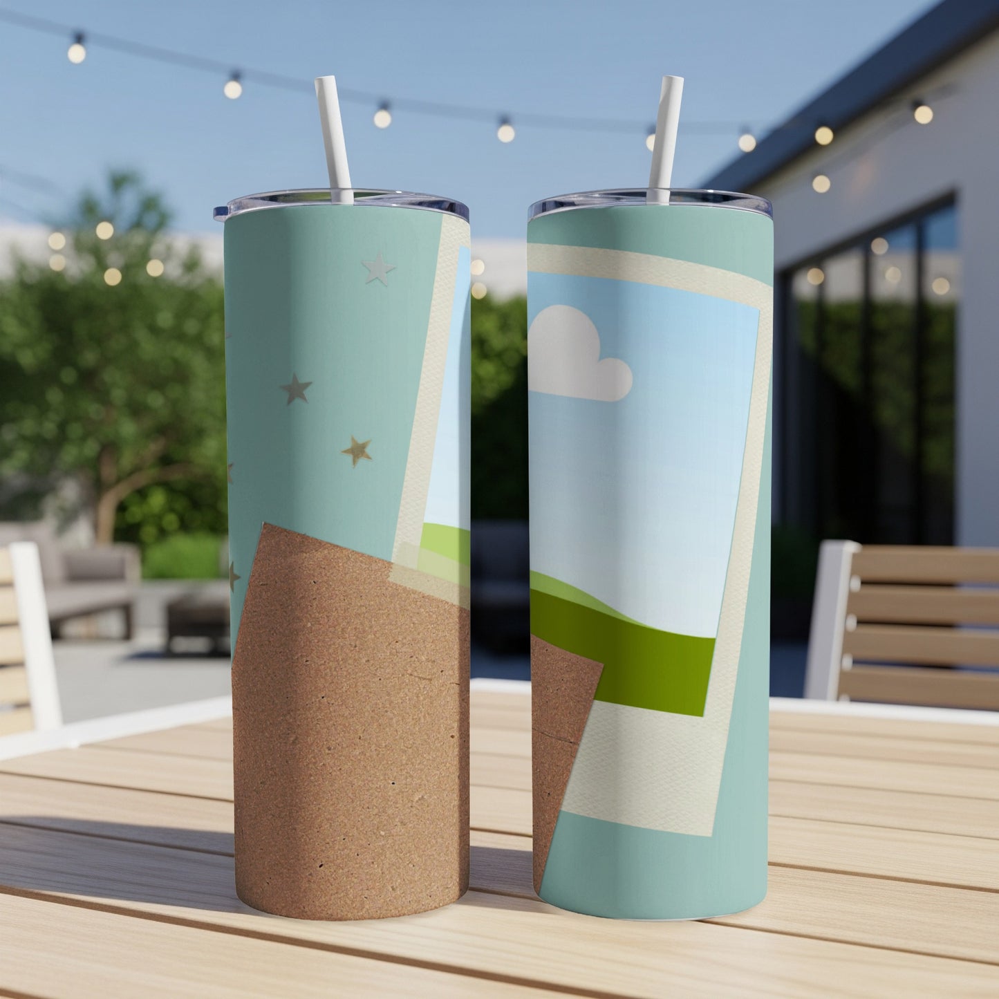 Two tumblers with straws on a wooden table with a background of outdoor seating.