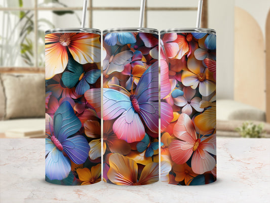 Three tumblers with colorful butterfly and flower designs, shown on a counter.