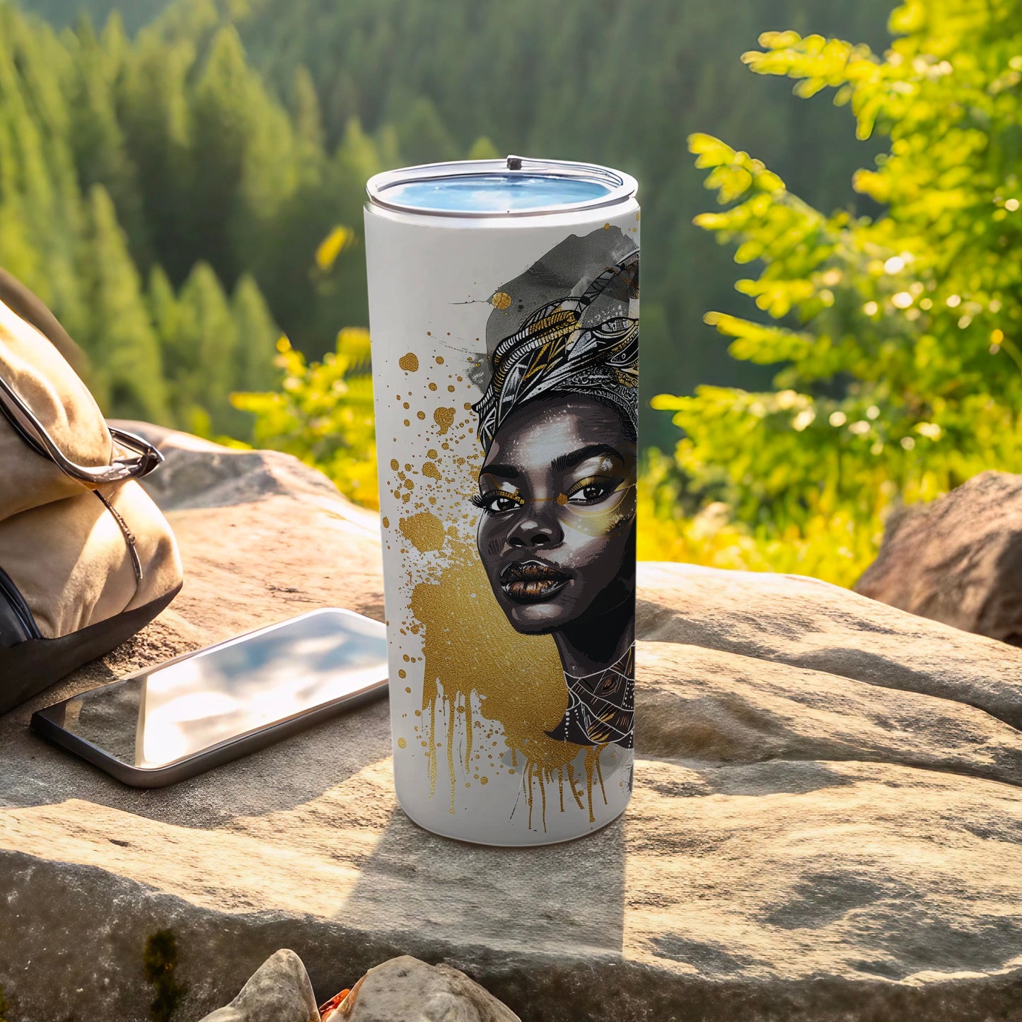 White tumbler with gold splatter and portrait of a Black woman with ornate headwear.