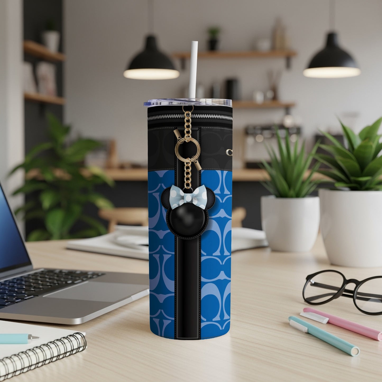 Tumbler with blue C pattern, black zipper detail, and Minnie Mouse keychain charm.