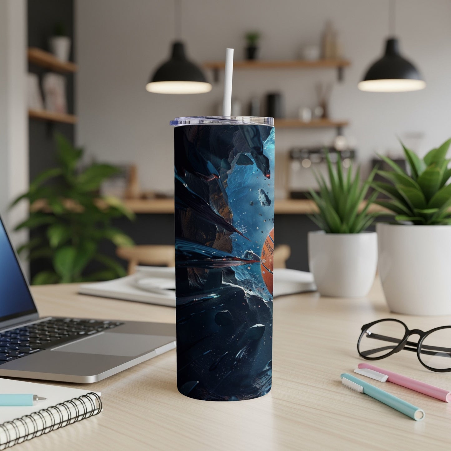 Tall tumbler with space-themed design and straw.