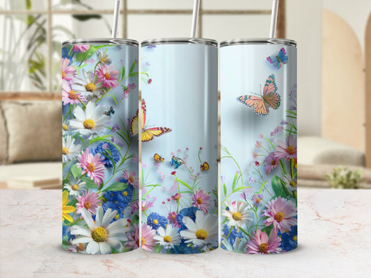 Floral and butterfly design on three tall, slender tumblers.
