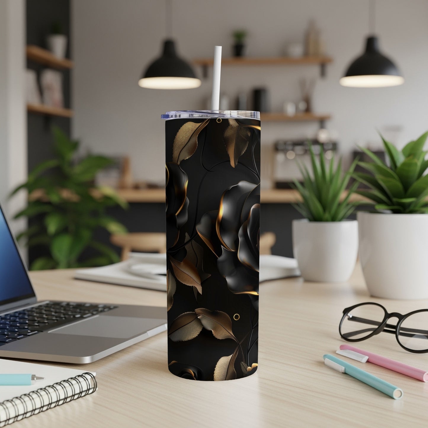 Black rose tumbler with gold accents on a desk.