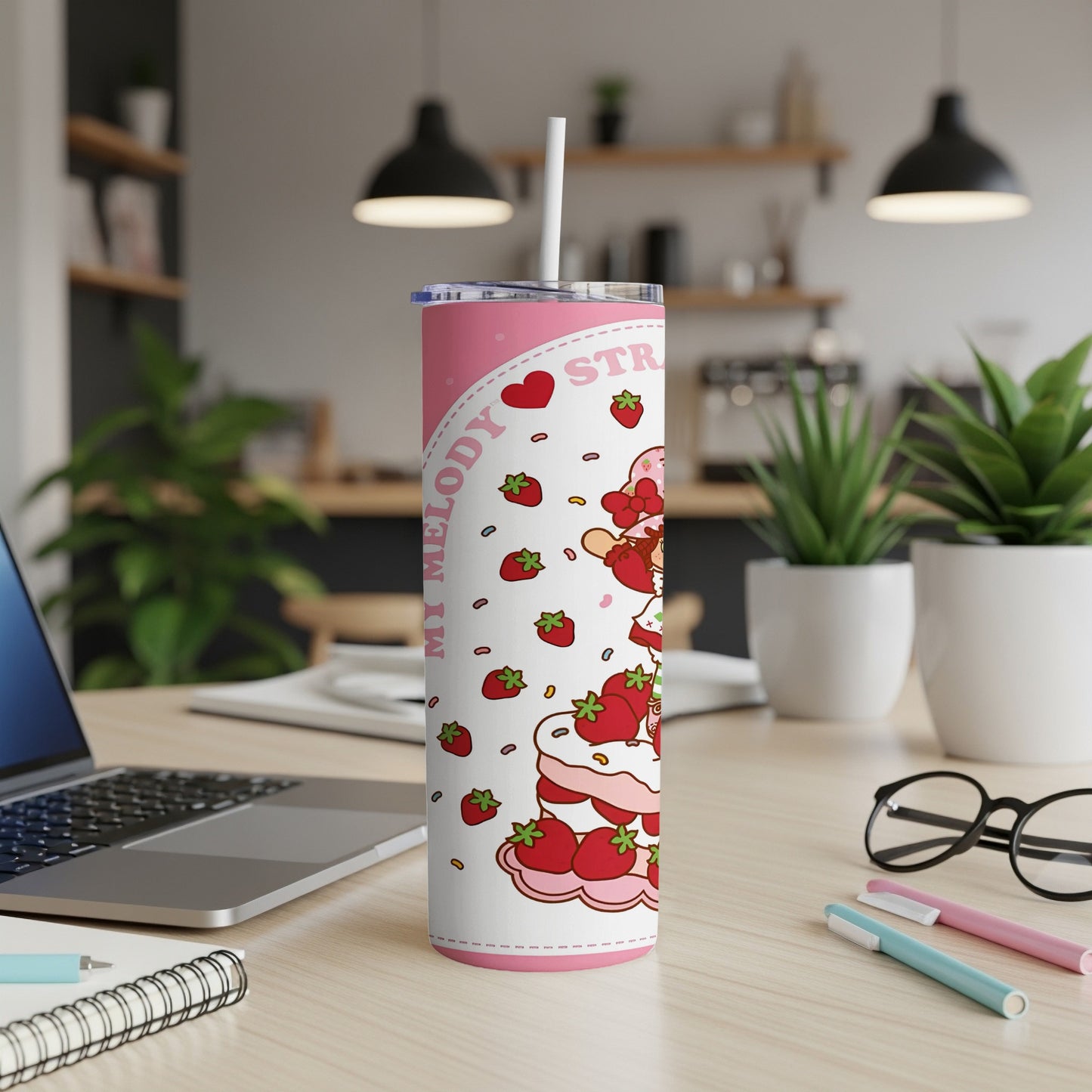 My Melody tumbler with strawberries and a pink lid, on a desk.