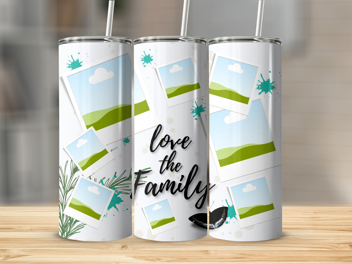 Tumbler with "love the Family" text, scattered photos, green splatters, and butterfly.