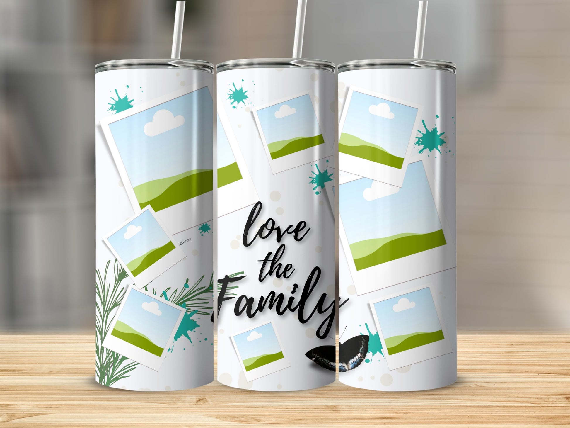 Tumbler with "love the Family" text, scattered photos, green splatters, and butterfly.