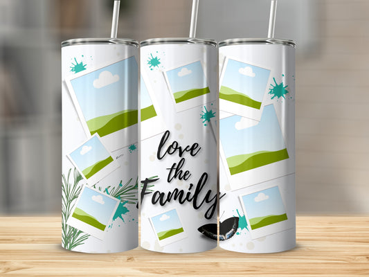Tumbler with "love the Family" text, scattered photos, green splatters, and butterfly.