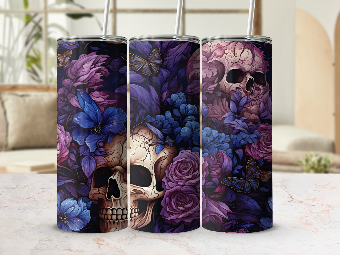 Three tumblers with a dark floral and skull design featuring butterflies.