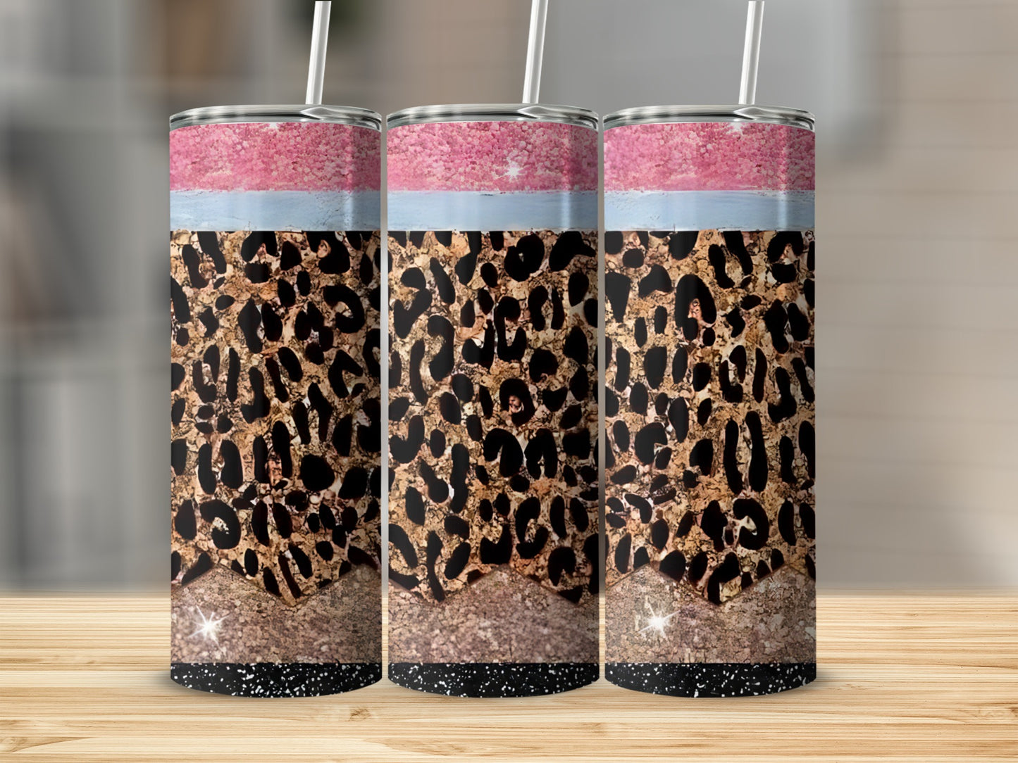 Three tumblers with leopard print, pink, and blue glitter patterns.