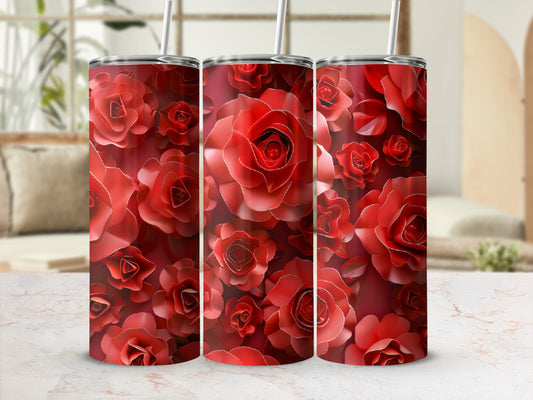 Three red rose-patterned tumblers with straws on a marbled surface.