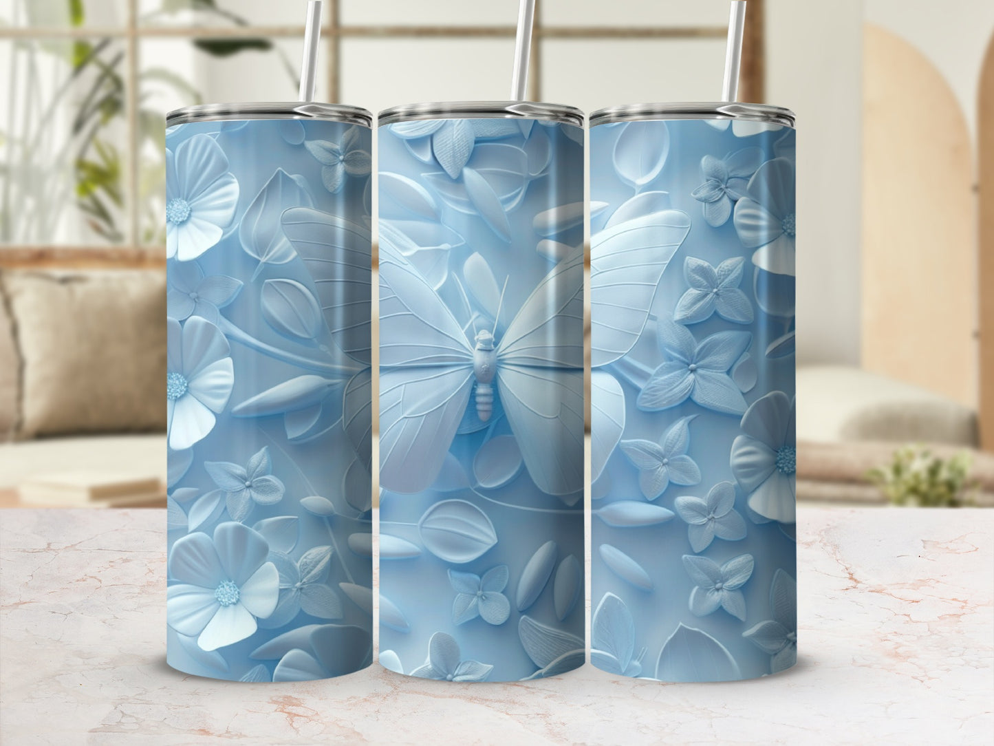 Three pale blue tumblers with embossed floral and butterfly designs.