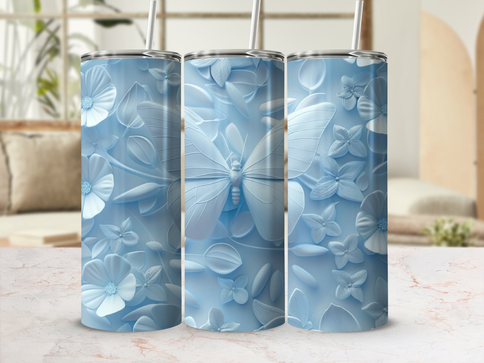 Three pale blue tumblers with embossed floral and butterfly designs.