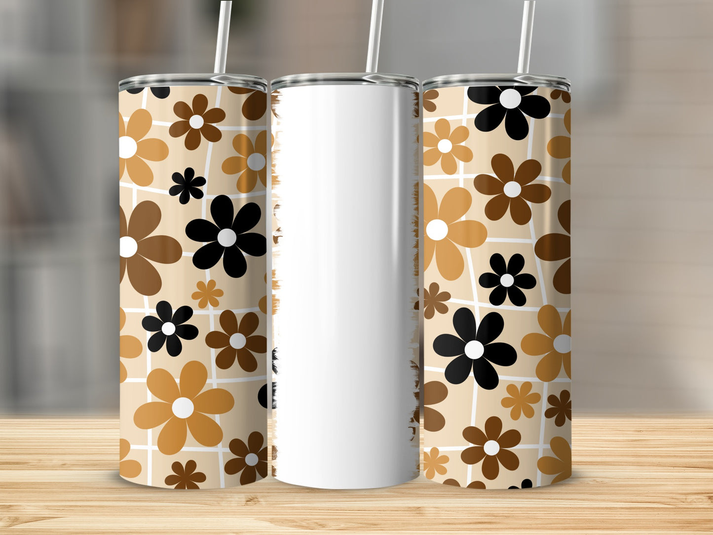 Three tumblers with brown, tan, and black floral patterns on a wooden surface.