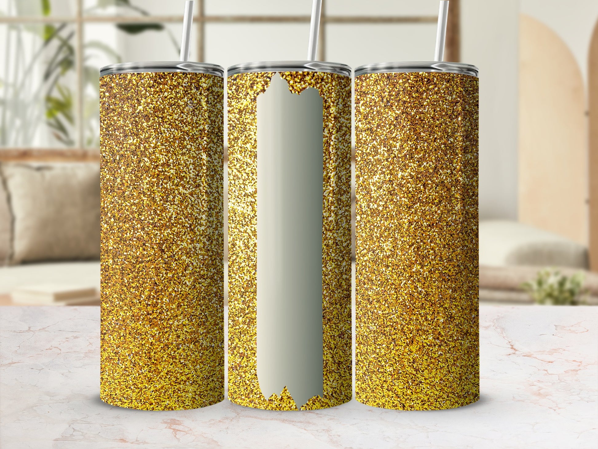 Three gold glitter tumblers with straws in a studio setting.