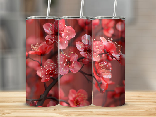 Red cherry blossoms adorn three tumblers on a wooden surface.