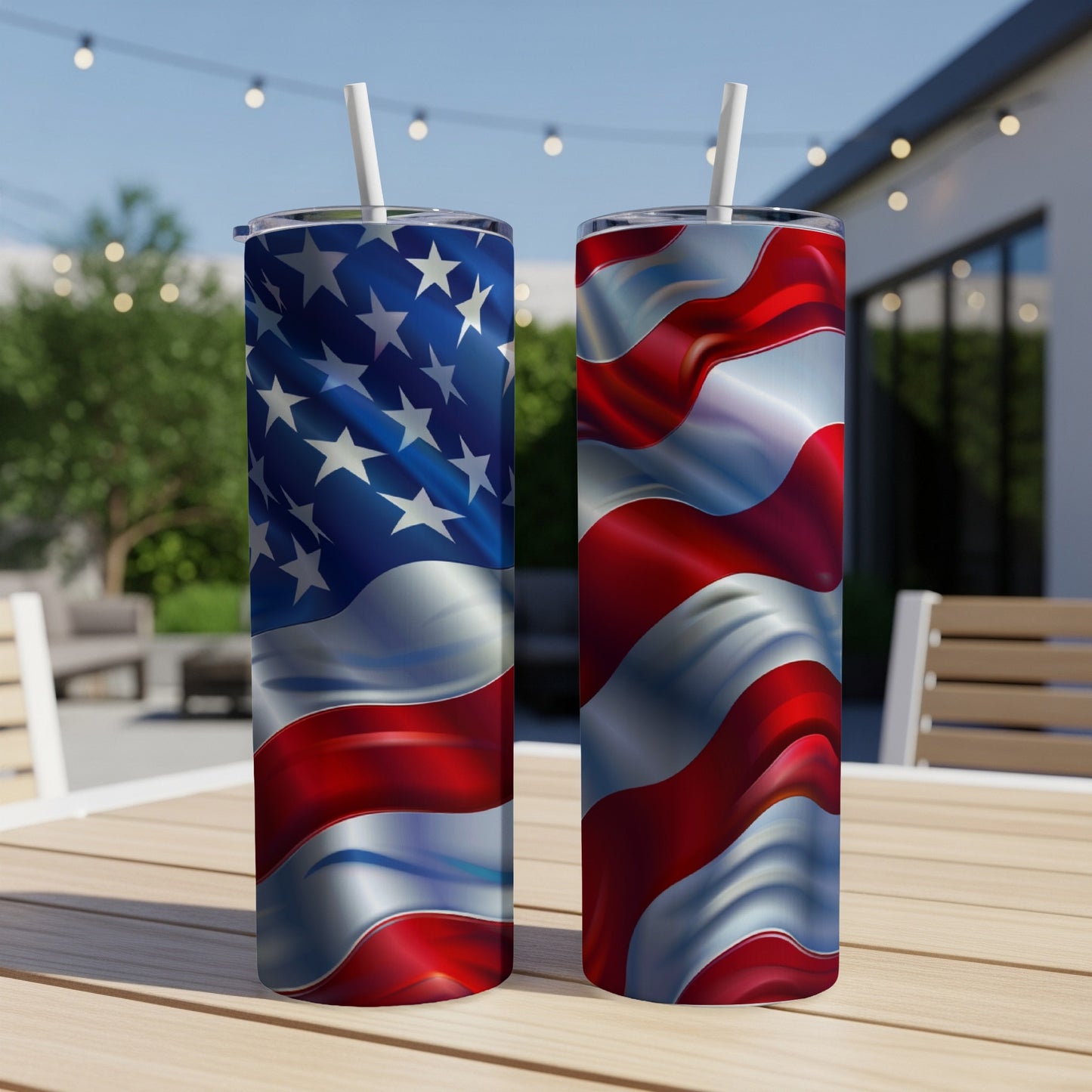Two American flag tumblers on a table outdoors.
