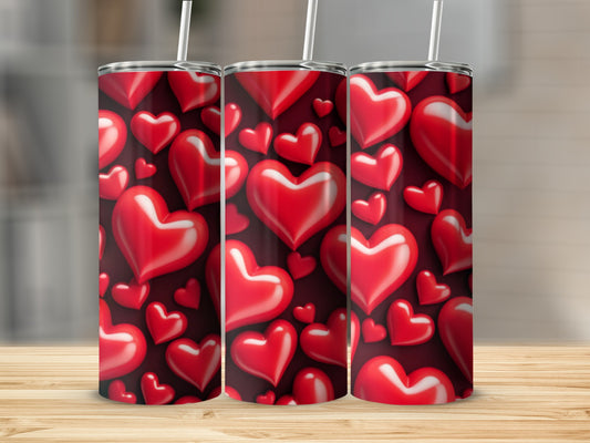 Three tumblers decorated with a pattern of glossy red hearts on a dark background.