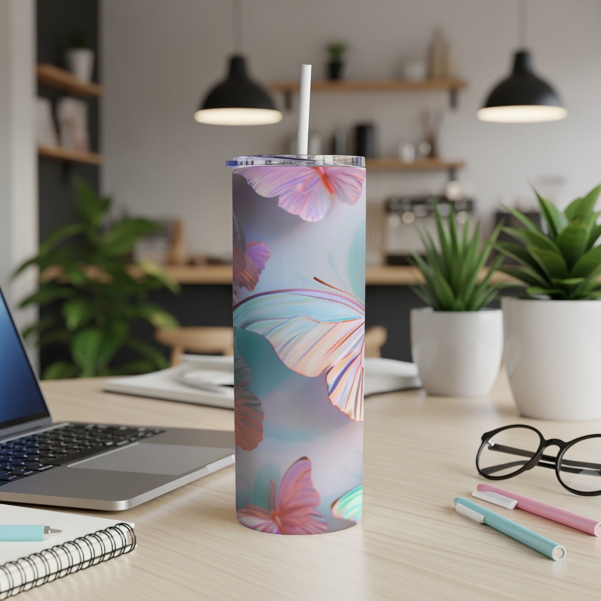 Pink and blue butterfly pattern on a white insulated tumbler with straw.