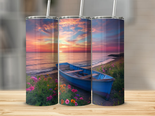 Blue rowboat on a beach at sunset with colorful flowers.