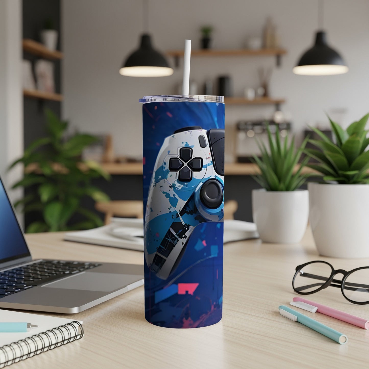 Travel tumbler with a blue and white video game controller design.