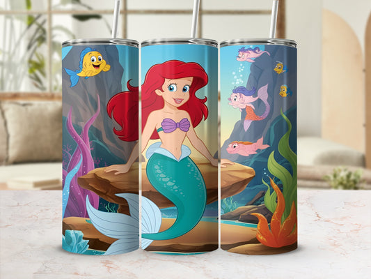 Ariel the mermaid and Flounder swim in a coral reef, on a tumbler.