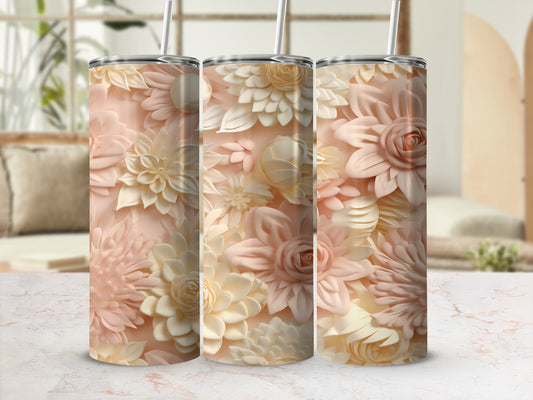 Three floral patterned tumblers with straws on a marble surface.