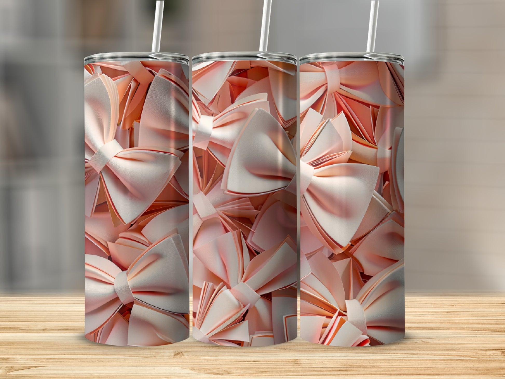 Three tumblers with a repeating pattern of pink and white ribbon bows.