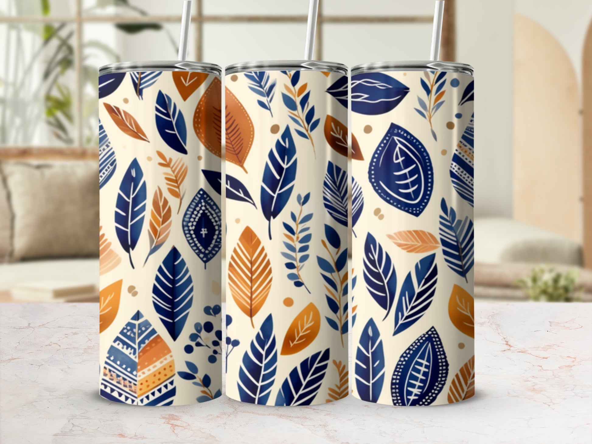 Three tumblers with a cream background and a pattern of blue and orange leaves.