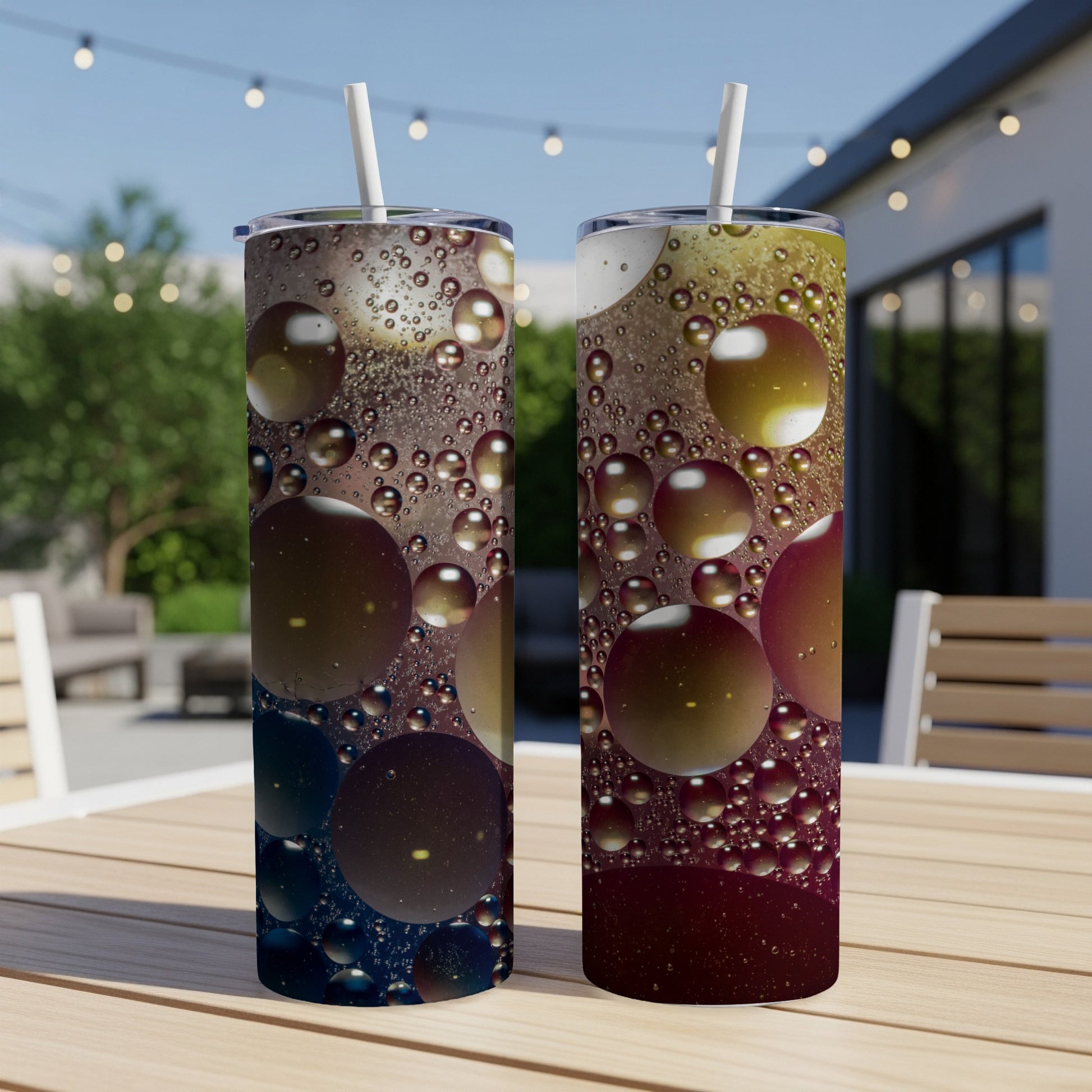 Two tumblers with an abstract oil and water bubble design on a table.