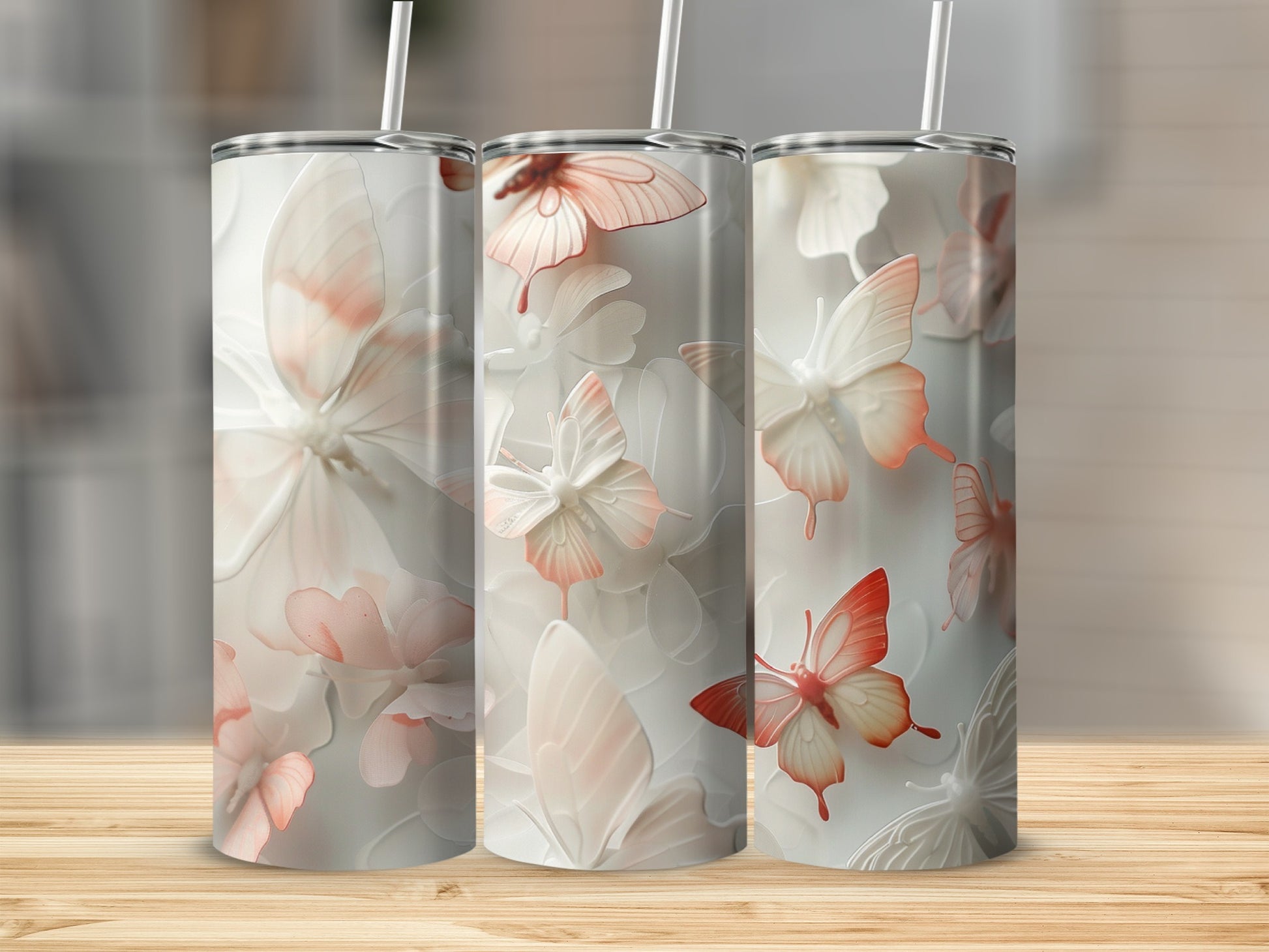 Three tumblers with a delicate butterfly and floral design.