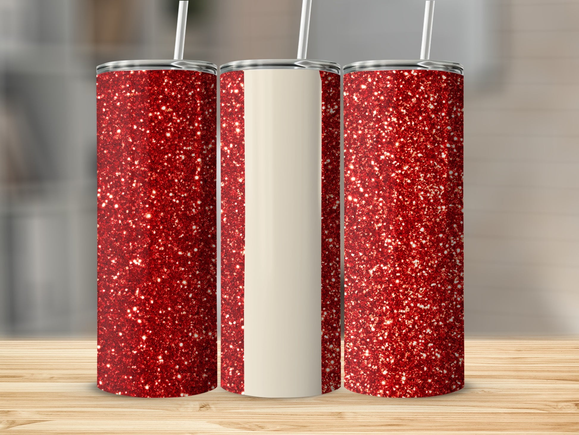 Three glittery red tumblers with white stripes on a wooden surface.