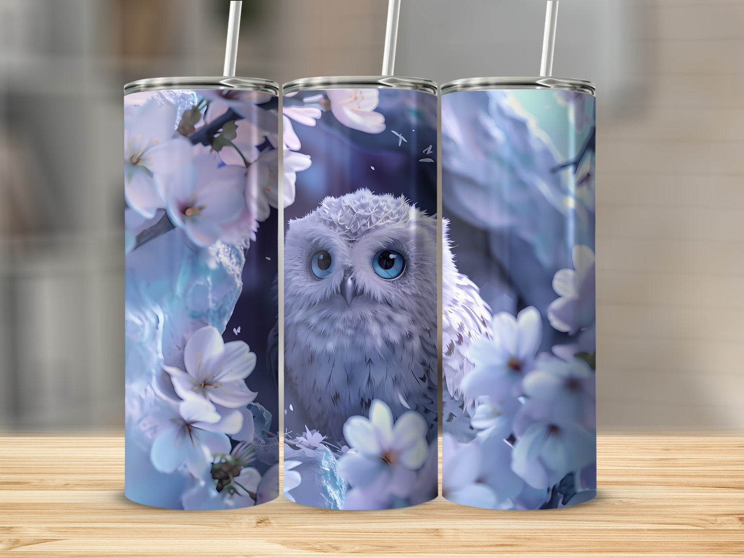 White owl with blue eyes surrounded by white cherry blossoms on three tumblers.
