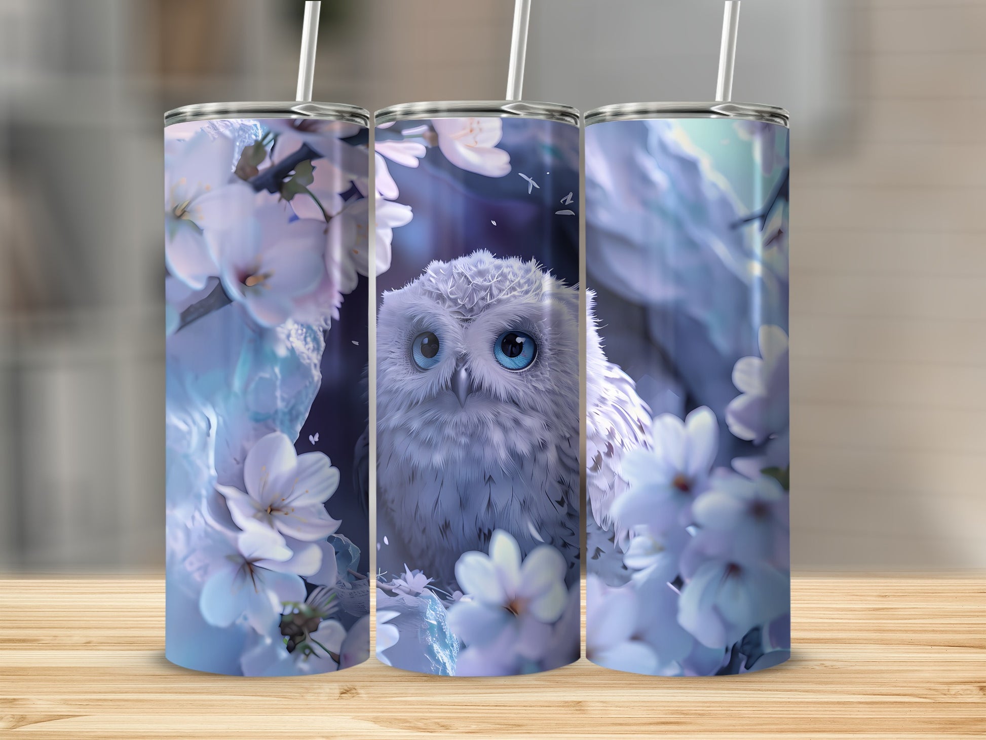 White owl with blue eyes surrounded by white cherry blossoms on three tumblers.