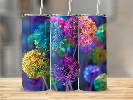 Three colorful dandelion-like designs on tumblers against a blurred background.