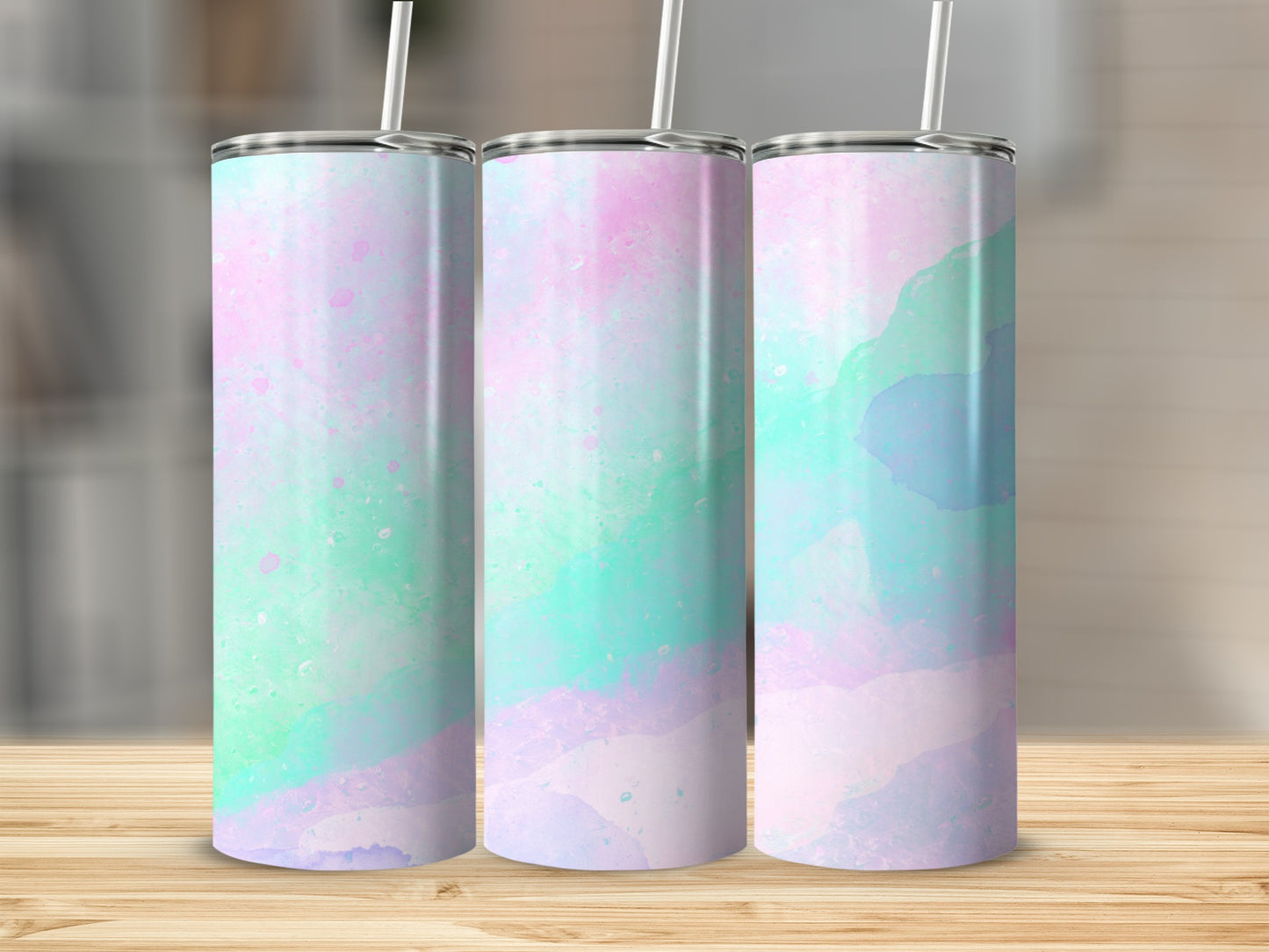 Three tumblers with a watercolor-style design in pastel pink, blue, and green.