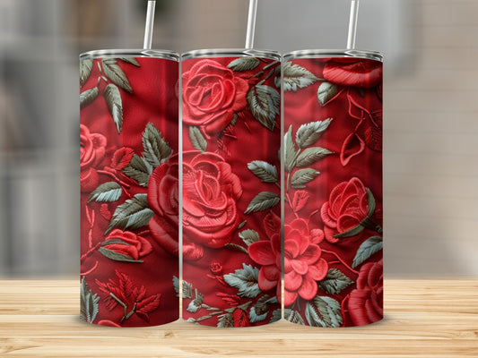 Three red tumblers with embroidered rose patterns.
