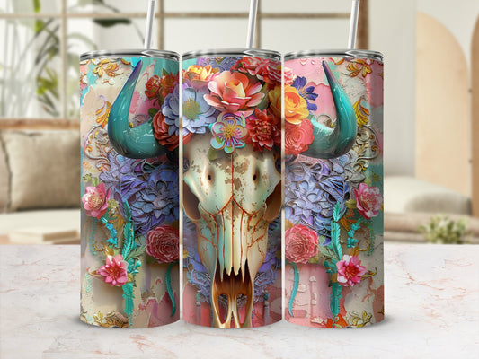 Floral skull tumbler with straw on marble surface.