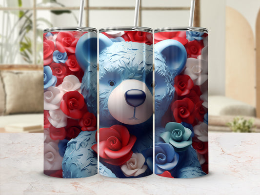 Blue teddy bear with red and blue roses on a tumbler.