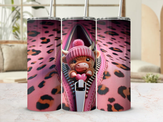 Pink leopard print tumbler with zipper revealing cute cartoon cow in pink hat.