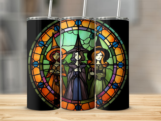 Three stained glass witches with pointy hats and colorful robes.