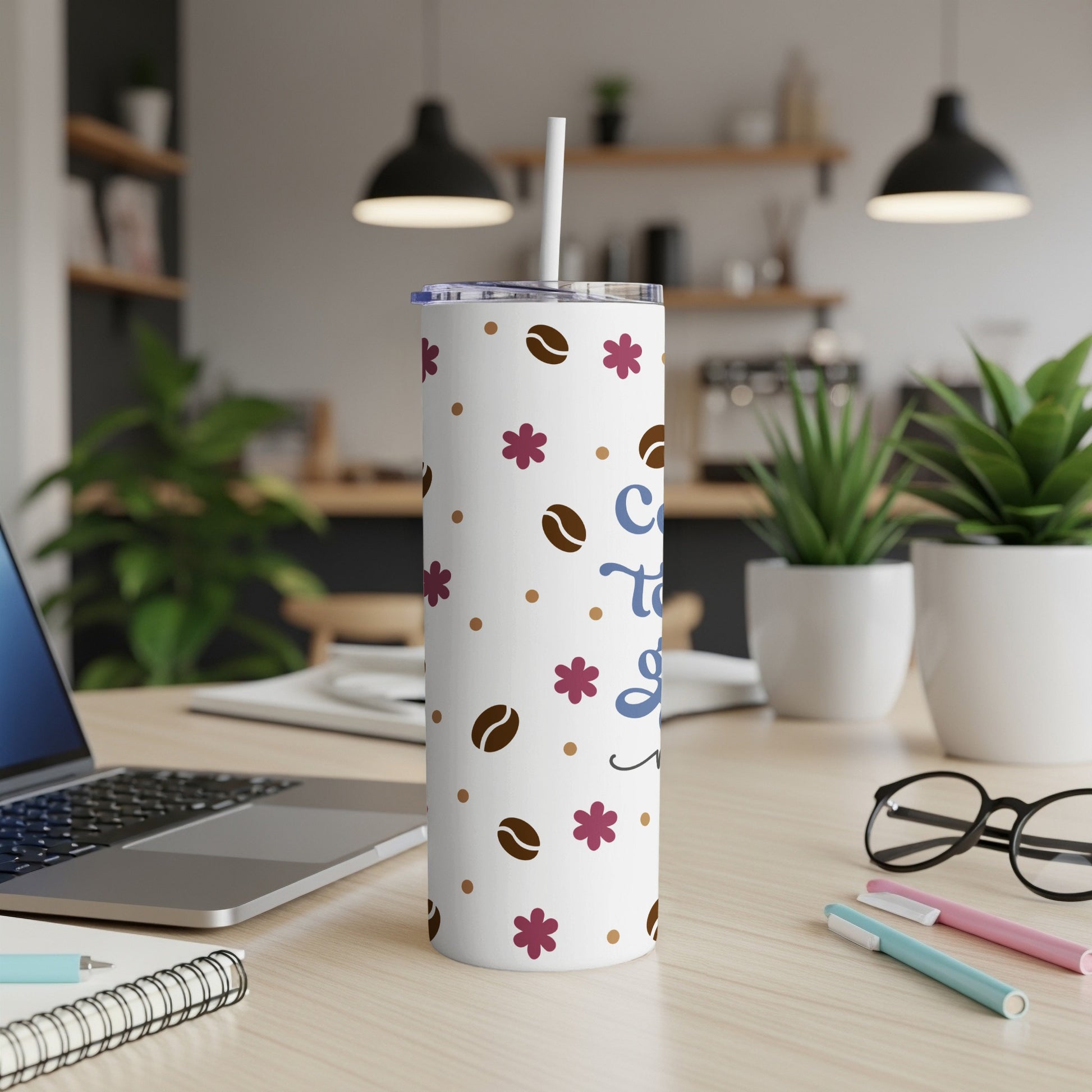 White tumbler with coffee beans and flower pattern, "Coffee to go" text.