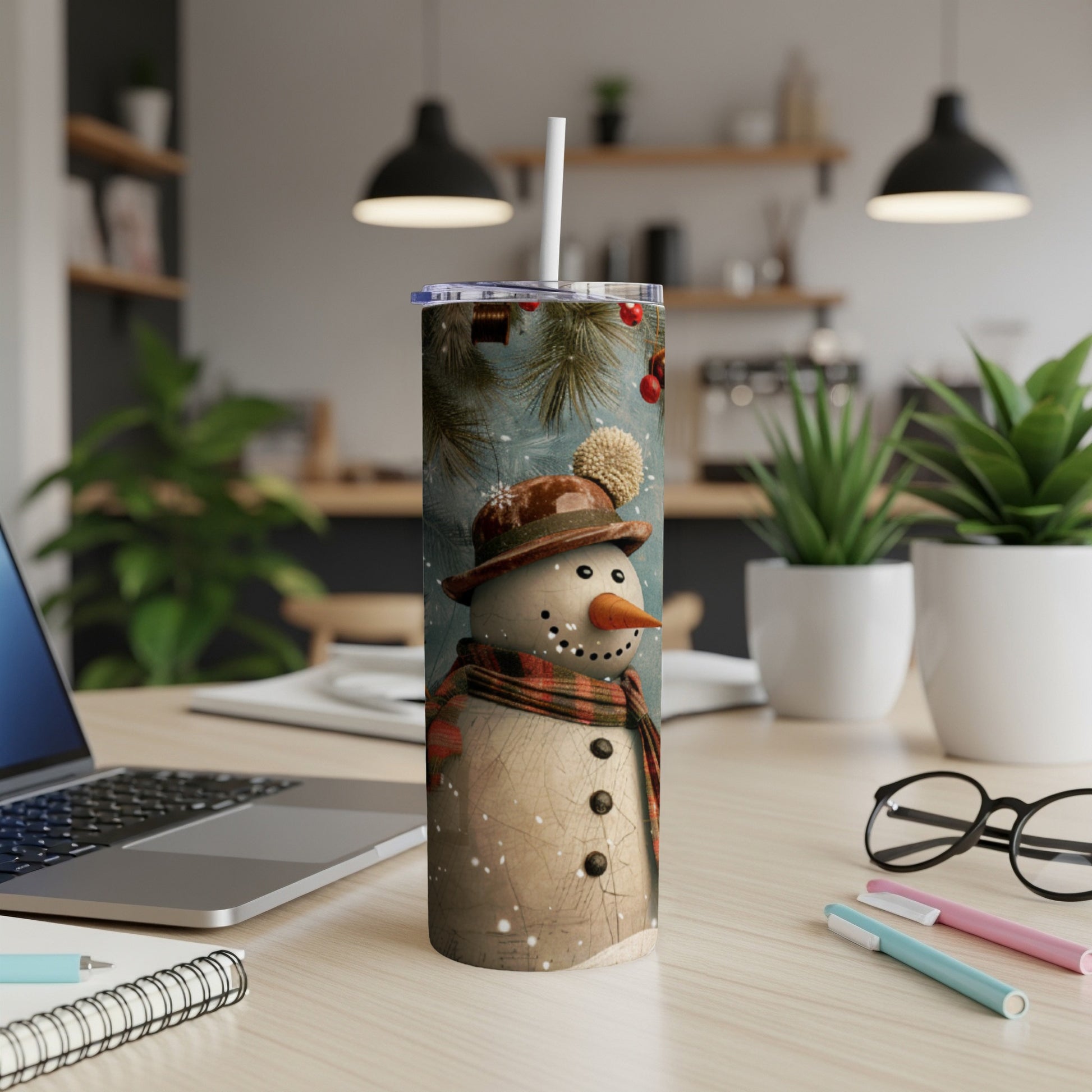 Snowman tumbler with checkered scarf and knit hat in a cozy setting.