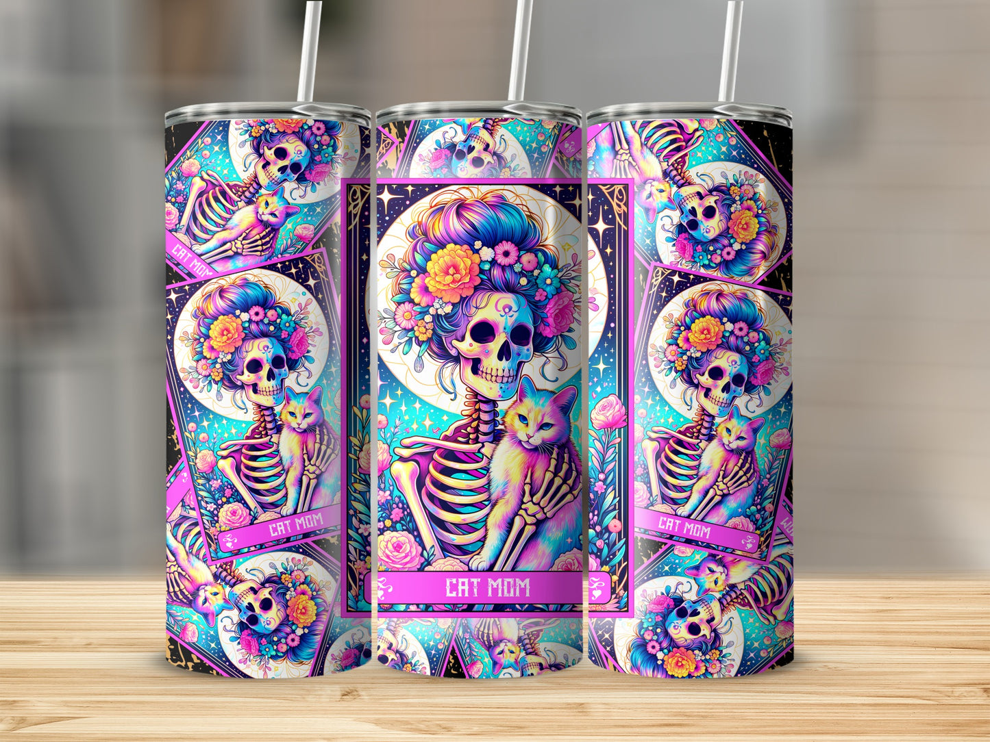 "Cat Mom" tumbler with a skeleton holding a cat and floral skull art.